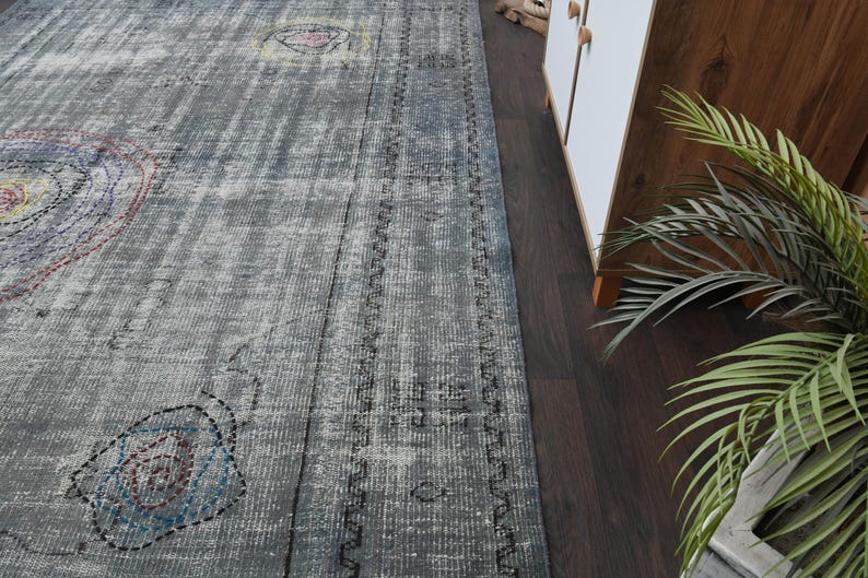 May include: A gray and white patterned rug with a distressed look. The rug has a border of dark blue and white.