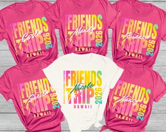 May include: A collection of pink t-shirts and one white t-shirt, each featuring a colorful "FRIENDS TRIP HAWAII 2026" design with a personalized name. The shirts are short-sleeved and have the text "MAKING MEMORIES TOGETHER".