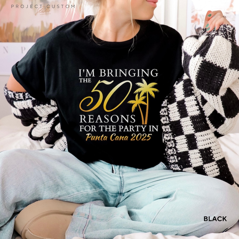 May include: Black t-shirt with gold text that reads "I'M BRINGING THE 50 REASONS FOR THE PARTY IN Punta Cana 2025" and palm tree graphics. The shirt is paired with light blue jeans and a black and white checkered sweater.