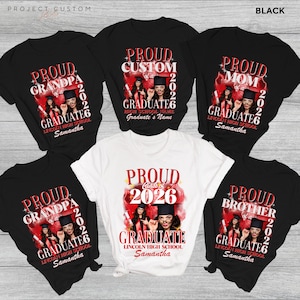 May include: A collection of black and white graduation t-shirts. Each shirt has a red and white design with the words "Proud Grandpa," "Proud Mom," "Proud Brother," and "Proud Graduate." A white shirt says "Proud Class of 2026."