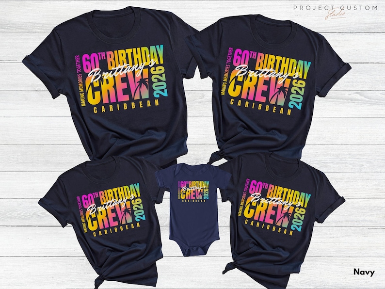 May include: Navy blue t-shirts and a onesie with a colorful graphic. The design includes the text "60th Birthday Crew Brittany Caribbean 2026" with palm trees. The shirts are for a family or group.