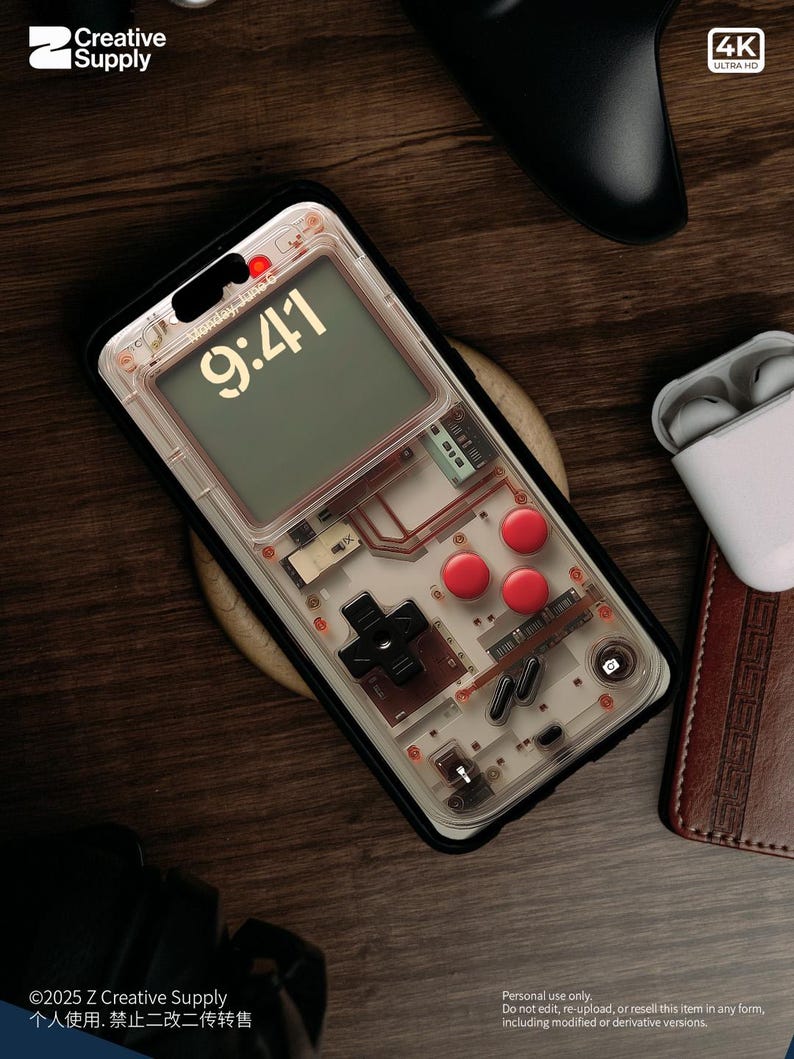 May include: A clear phone case with a retro video game design. The case has a black border and a transparent back that shows the internal components of a video game console. The case has a red and black button design and a digital clock display that reads "9:41".
