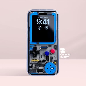 May include: Transparent phone case with a blue and grey retro video game design. The phone screen shows the time as 9:41 on Monday, June 6. The case features a cross-shaped directional pad, buttons, and the text "Creative Supply".