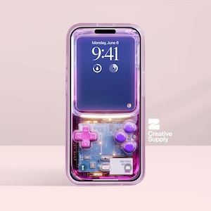May include: A transparent phone case with a retro video game design. The case features a pink D-pad and purple buttons, with a circuit board visible. The phone screen shows the time and date. The Creative Supply logo is visible.