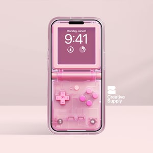 May include: A pink phone case designed to look like a retro handheld gaming device. The case is open, showing the phone screen with the date and time. The case has a cross-shaped directional pad and pink buttons.