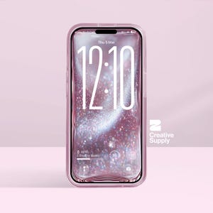 以下が含まれることがあります： 透明なピンク色の携帯電話ケースが、12時10分を表示するスマートフォンを囲んでいます。画面はピンク色でキラキラしています。表示されている日付は3月5日（木）です。Creative Supplyのロゴが見えます。