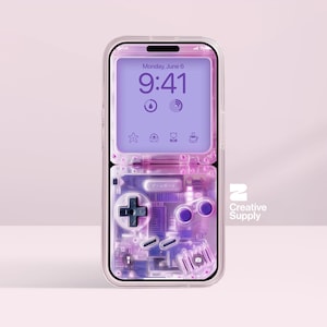 May include: Transparent phone case with a retro video game design. The case has a purple and pink colour scheme, with a D-pad, buttons, and internal components visible. The phone screen shows the time and date.