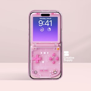 May include: A pink phone case with a transparent design, featuring a built-in game controller layout. The phone screen displays the date and time. The case has a protective frame and a hinged top. The Creative Supply logo is visible.
