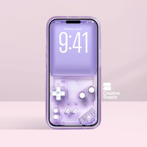 May include: A transparent, lilac phone case featuring a retro video game controller design. The phone screen shows the time 9:41, the date, and the Optus network. The case has a clear border and the Creative Supply logo.
