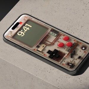 May include: A clear phone case with a retro game console design. The case has a transparent back that reveals the internal components of the phone. The case has a black border and a red button on the side. The phone screen displays the time 9:41.