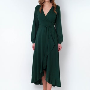 May include: A long-sleeved, emerald green wrap dress with a ruffled hem and a tie at the waist.