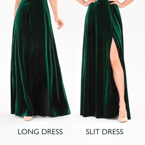 May include: Two women wearing the same emerald green velvet dress. The dress on the left is a long dress. The dress on the right has a slit up the side.