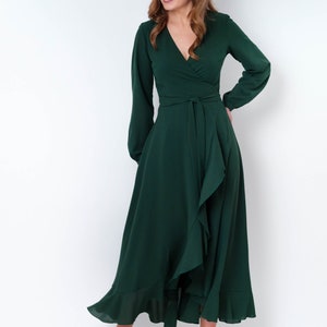 May include: A long-sleeved, emerald green wrap dress with a ruffled hem and a tie at the waist.