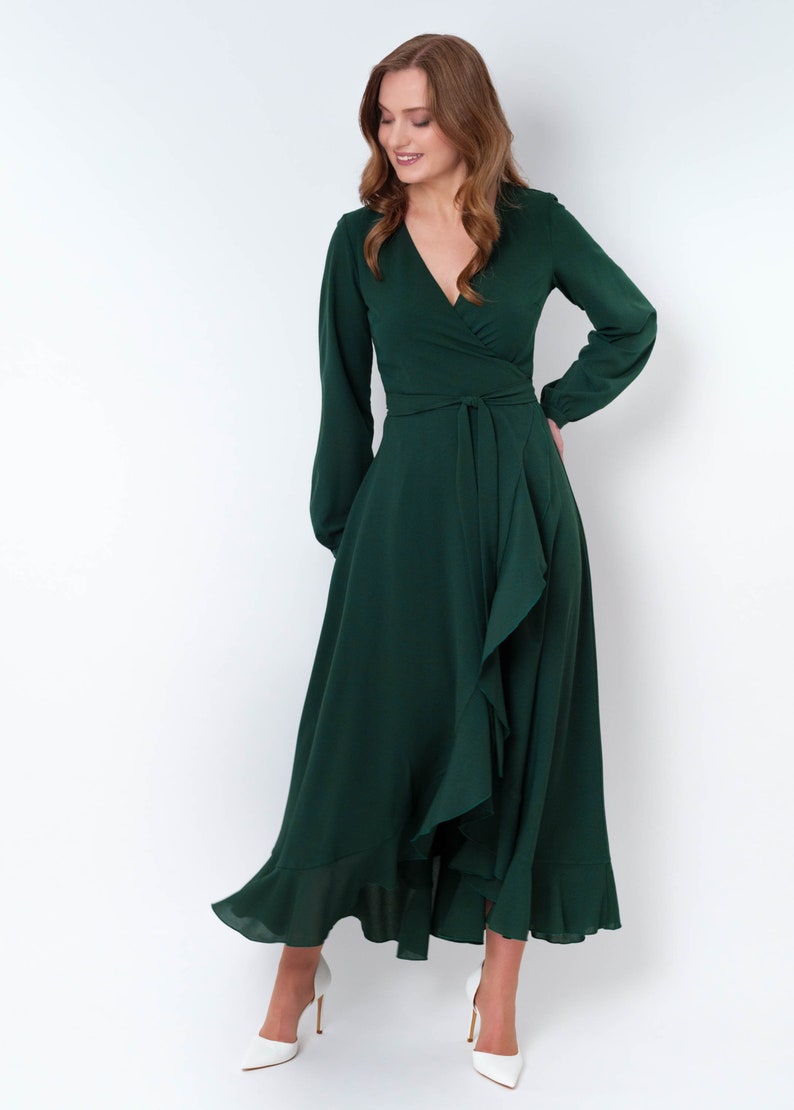 May include: A long-sleeved, emerald green wrap dress with a ruffled hem and a tie at the waist.
