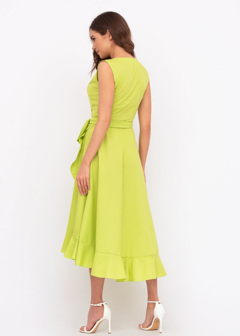 May include: A lime green midi dress with a ruffled hem and a tie at the waist.