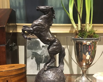 The world is best viewed through the ears of a horse.An amazing unique Cold Cast Bronze Rearing Horse on a Sphere Of The World  Sculpture UK