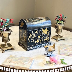 So long,fare the well.Pip Pip Cheerio,be back soon,Mrs Bennet said to Jane & Mr Bingley holding an Antique Black Painted Toleware Tea Caddy