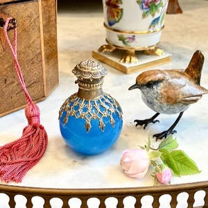 More perfume Lady Caroline?Her maid said holding an Antique Blue Glass Ormolu Scent Bottle.Its not just perfume its Chanel No5, she replied