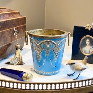 May include: A set of three ceramic mugs with a speckled, matte finish. The mugs are in shades of cream, light gray, and dark gray. Each mug has a simple, minimalist design, perfect for coffee or tea.