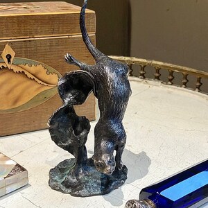 A Magical free flowing Solid Bronze Otter Sculpture with a warm rich patina,subtle bronze highlights capturing the true essence of the Otter