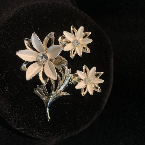 Vintage silver tone and white enamel flower brooch, round crystal rhinestone center and matching earrings