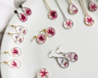 NEW-Purple or pink flower earrings or necklace (geranium flower) under resin