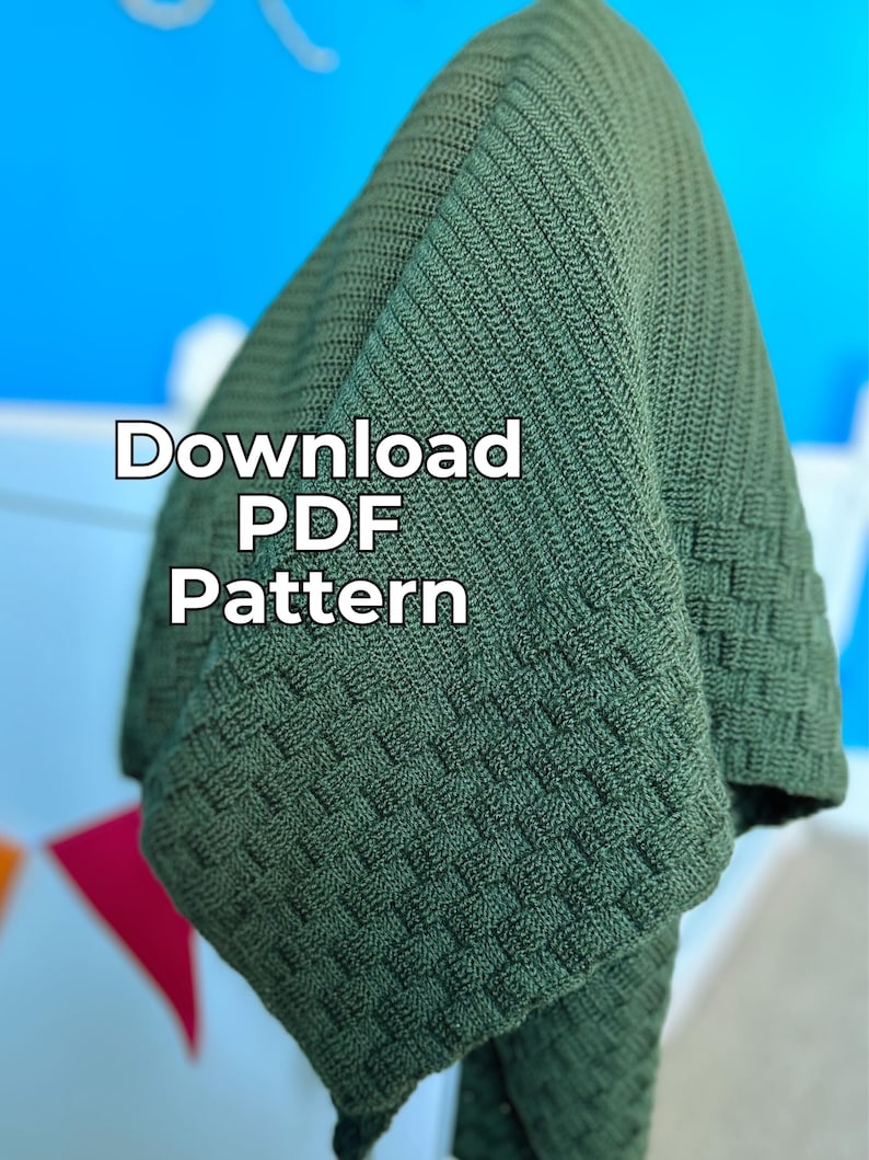 May include: Olive green knitted blanket with a textured basketweave pattern. The blanket is folded, revealing the intricate stitchwork. Text on the blanket reads "Download PDF Pattern".