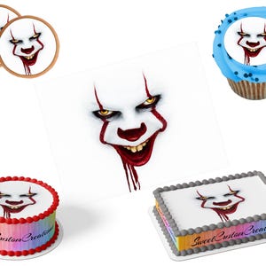 May include: An assortment of edible decorations featuring a scary clown face. The image includes two round toppers, a cupcake, a square cake, and a round cake. The cakes have rainbow borders and the text "Sweet Custom Creations".