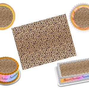 May include: A set of edible cake toppers featuring a leopard print design. The set includes a round cake topper, a rectangular cake topper, and two square cake toppers. The cake toppers are printed with a brown and black leopard print pattern.