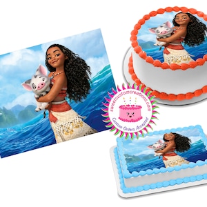 May include: A round and a rectangular cake decorated with edible images of Moana and Pua from the Disney movie Moana. The round cake has orange frosting and the rectangular cake has blue frosting. The images are printed on edible paper and show Moana holding Pua, a pig, in her arms. The background of the images is a blue ocean with islands in the distance.