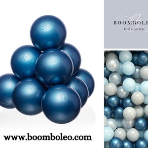 May include: A pyramid of navy blue play balls with a shiny surface. Each ball has a small, circular marking. The image also includes a mix of white, light blue, and navy blue balls, and the text "BOOMBOLEO kids shop" and "www.boomboleo.com".