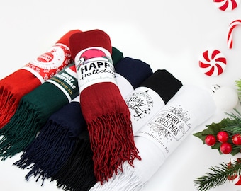 May include: Five different colored scarves with fringed edges, each wrapped around a white card with a festive holiday message. The messages include "Happy Holidays", "Merry Christmas", and "Merry Christmas".