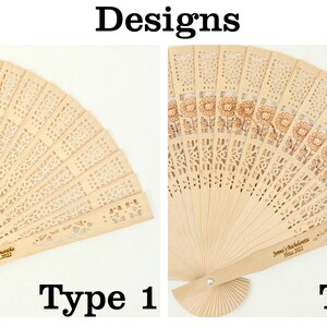 May include: Two wooden hand fans with different designs. The fan on the left has a simple, intricate cut-out design. The fan on the right has a floral design with a brown tint. Both fans have a personalised inscription on the handle.