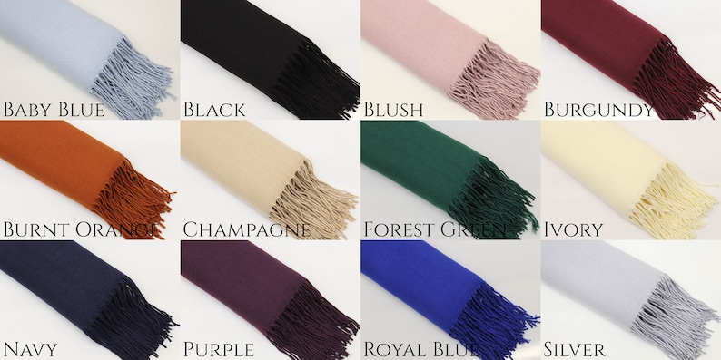 May include: A collection of 12 solid color scarves with fringe. The colors are baby blue, black, blush, burgundy, burnt orange, champagne, forest green, ivory, navy, purple, royal blue, and silver.