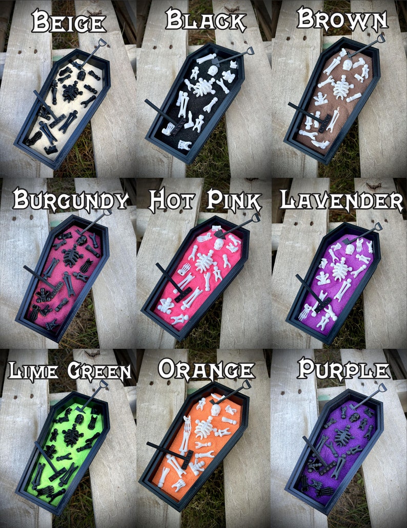 May include: Nine miniature coffins filled with sand and tiny skeleton bones. Each coffin is a different color: beige, black, brown, burgundy, hot pink, lavender, lime green, orange, and purple.