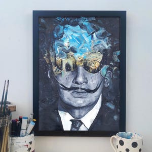 May include: A framed painting of a man with a moustache and sunglasses. The background is a blue and white abstract design.
