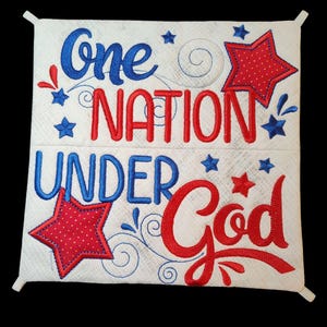 May include: White fabric square with red and blue embroidered text that reads "One Nation Under God" with stars and swirls.