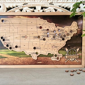 May include: A wooden map of the United States with baseball stadiums marked. The map is framed in wood and has a baseball-themed design with the text "The [Family Name] Family Baseball Travel Map".