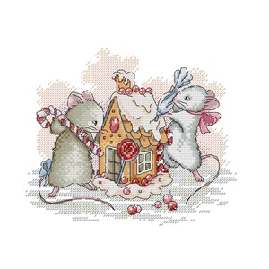May include: Two gray mice decorate a gingerbread house with candy canes and red and white sprinkles. The house has a white frosting roof and a red lollipop sticking out of the side.