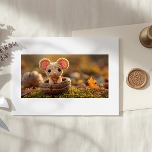 May include: A crocheted mouse figurine in a walnut shell is featured in a framed print. A bouquet of lavender tied with a light blue ribbon, a cream-colored envelope, and a wax seal are also present. The scene is set on a white, textured surface.