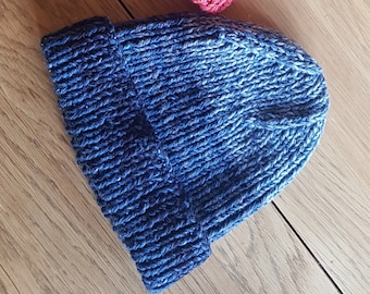 May include: Two knitted hats, one pink and red ombre with a pom pom and one blue ombre.