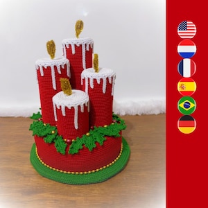 May include: A crocheted Christmas candle holder with four red candles and green holly leaves. The base is red with a green trim.