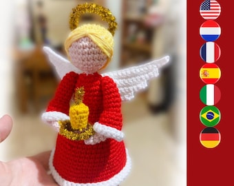 May include: A crocheted angel figurine featuring a red dress with white trim, yellow yarn hair, a gold tinsel halo, and white wings. The angel holds a small yellow candle with a gold tinsel base, crafted with detailed yarn stitching.