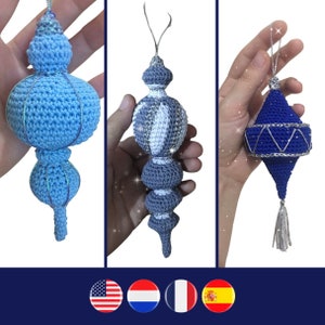 May include: Three crocheted Christmas ornaments in blue, white, and silver. The ornaments are all different shapes and sizes. The blue ornament is a teardrop shape with a silver tassel. The white ornament is a round shape with a silver trim. The silver ornament is a round shape with a white and silver pattern.