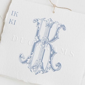May include: A light blue monogram design featuring the letters "IK" and "KI" with the word "DUOGRAMS" printed on a white textured paper. The design includes ornate flourishes and is tied with a twine string.