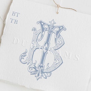 May include: A blue and white monogram featuring the letters "BT" intertwined. The monogram is in a vintage style with ornate flourishes. The text "DUOGRAMS" is also visible in the image.