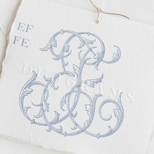 May include: A blue and white floral monogram design with the letters "EF" in a decorative font. The design is on a white background with the text "DUOGRAMS" below it.