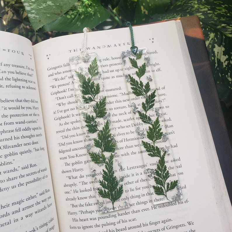 Green Fern Bookmark accompanied by silver glitter throughout as the default design. Gold and rose gold glitter is available upon request.
