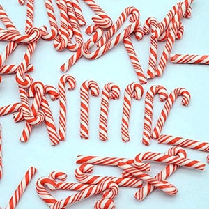 May include: A large group of red and white candy canes, a traditional Christmas treat.