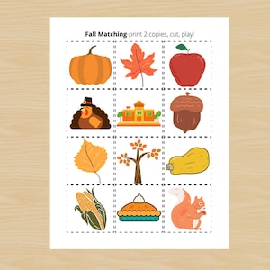 May include: A printable autumn-themed matching game with images of a pumpkin, maple leaf, apple, turkey, schoolhouse, acorn, leaf, tree, squash, corn, pie, and squirrel. The text "Fall Matching print 2 copies, cut, play!" is at the top of the page.
